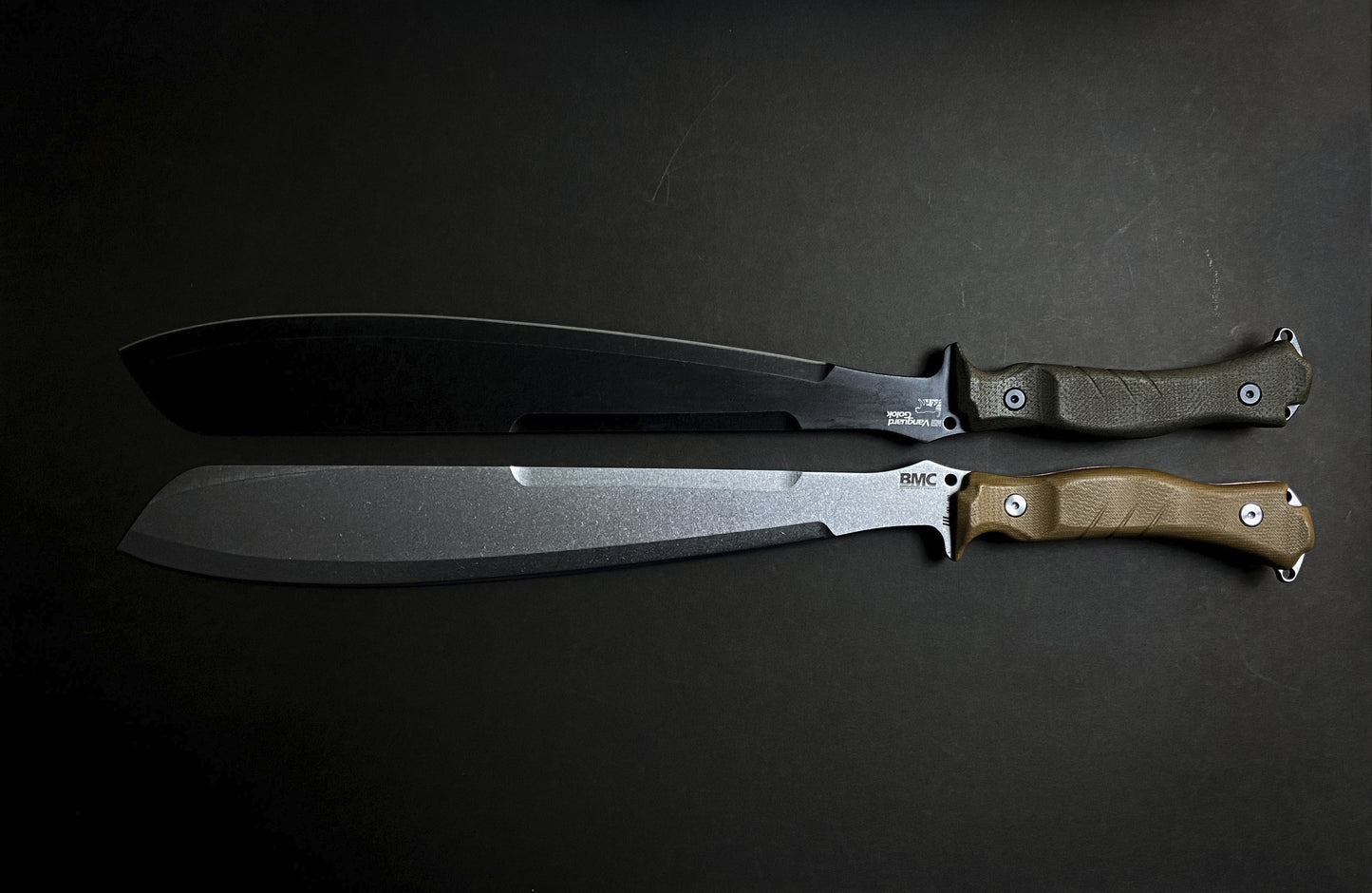Two BMC Goloks with micarta handles on a dark background